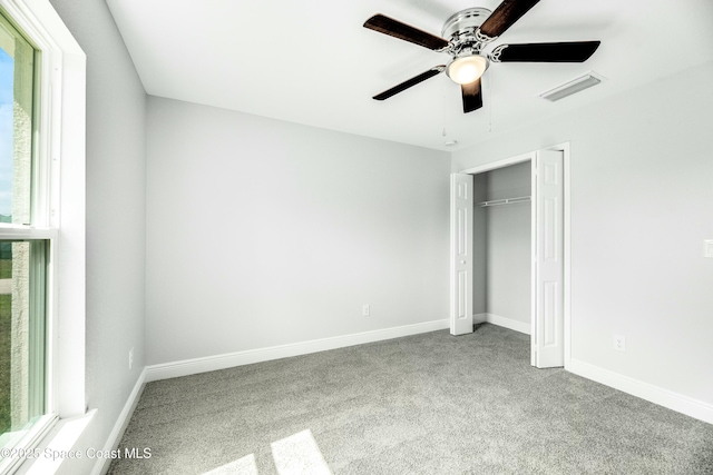 unfurnished bedroom with ceiling fan, carpet floors, and a closet