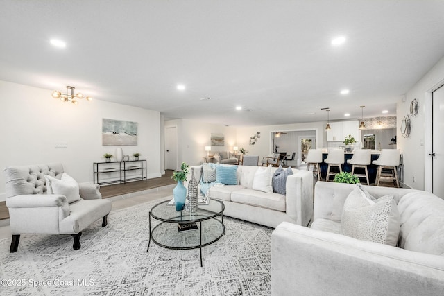 living room featuring a chandelier and light wood-type flooring