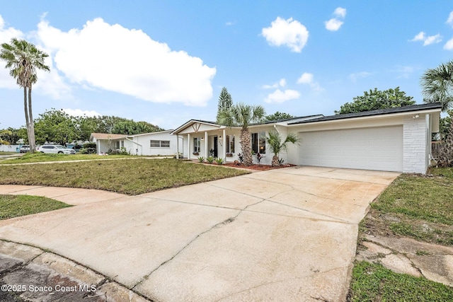 ranch-style house featuring a garage and a front lawn