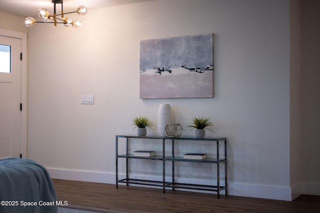 foyer featuring dark hardwood / wood-style floors and an inviting chandelier