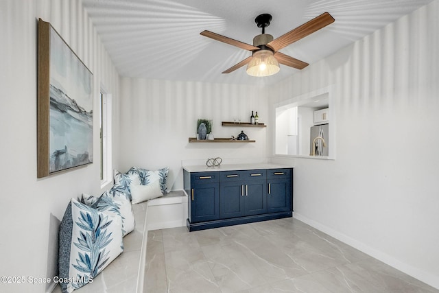 living area with ceiling fan