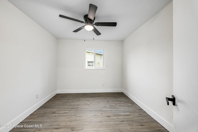 empty room featuring wood-type flooring and ceiling fan