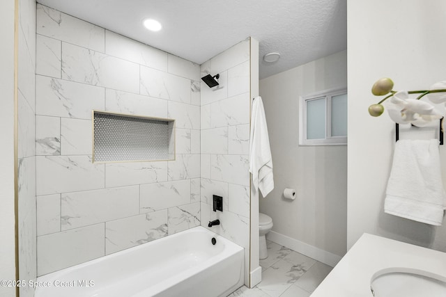 full bathroom featuring tiled shower / bath combo, sink, a textured ceiling, and toilet