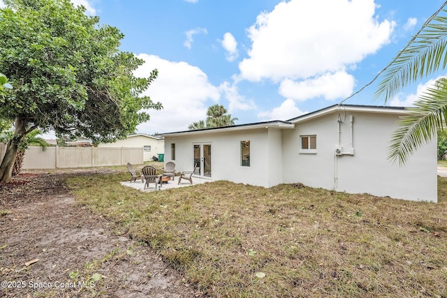 rear view of property with an outdoor fire pit and a patio