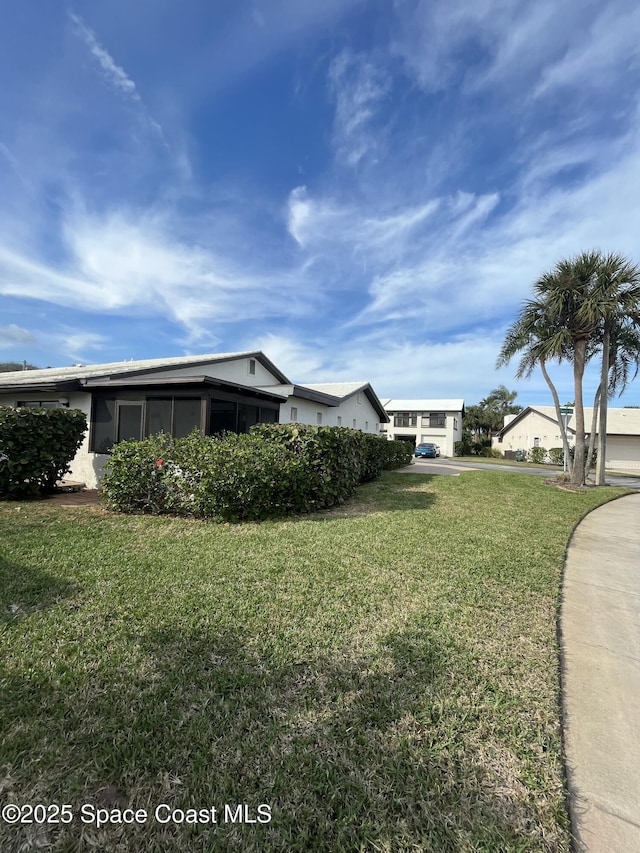 view of property exterior with a yard