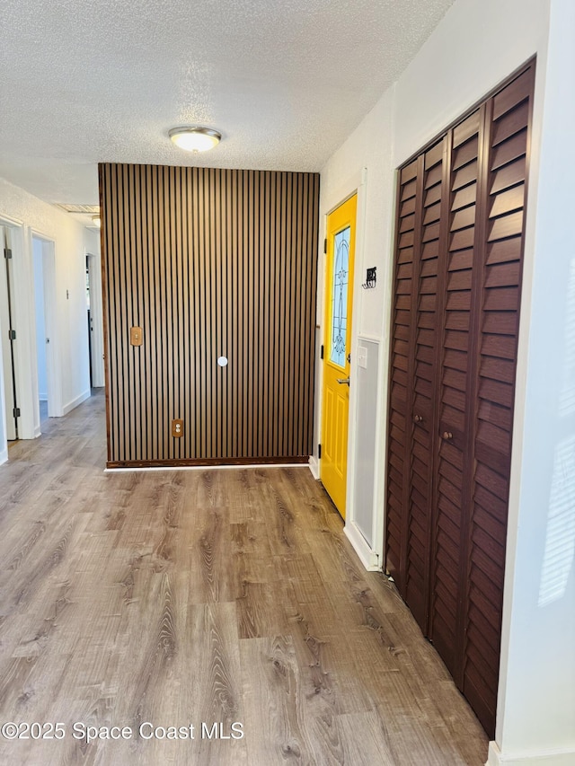 corridor featuring hardwood / wood-style floors and a textured ceiling