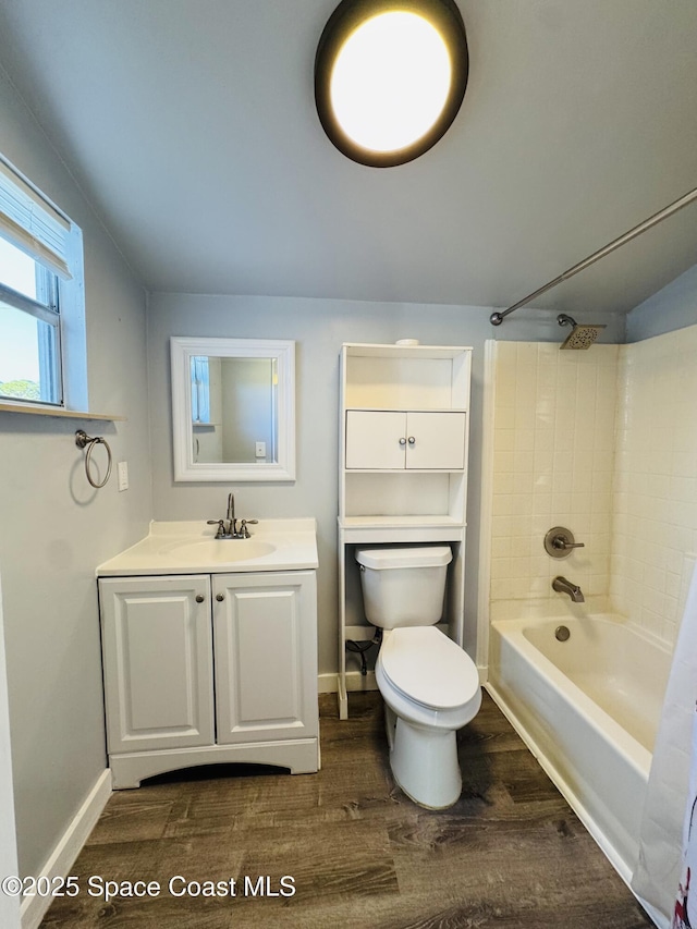 full bathroom featuring vanity, hardwood / wood-style floors, shower / tub combination, and toilet