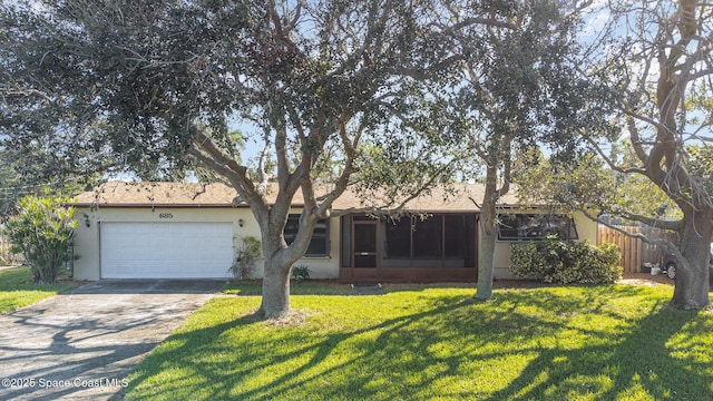 ranch-style house with a garage, a sunroom, and a front lawn