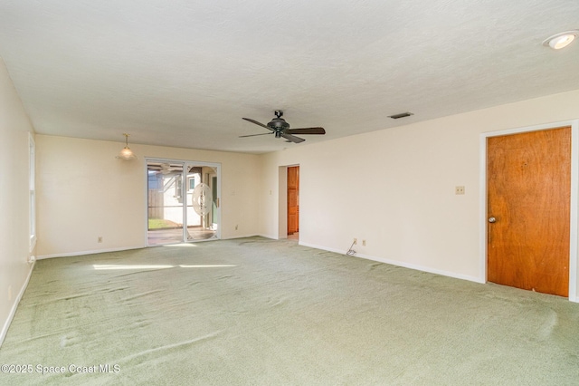 carpeted empty room featuring ceiling fan and a textured ceiling