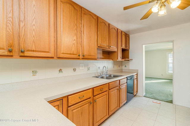 kitchen featuring sink, ceiling fan, black dishwasher, tasteful backsplash, and light tile patterned flooring