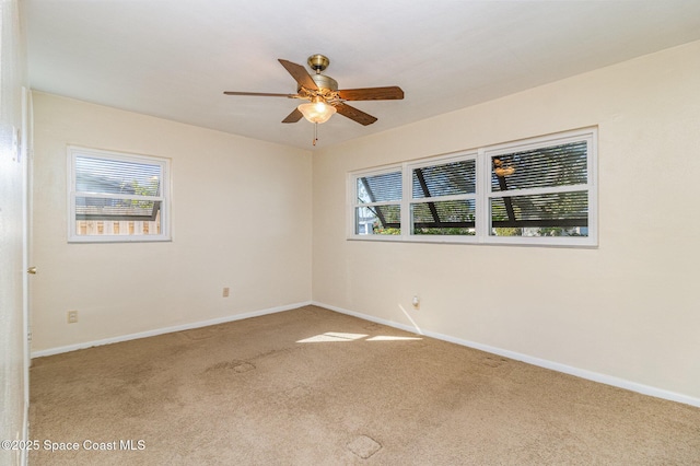 carpeted spare room with ceiling fan