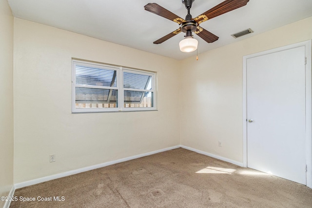 carpeted empty room with ceiling fan