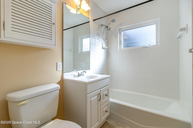 full bathroom with tiled shower / bath combo, vanity, and toilet