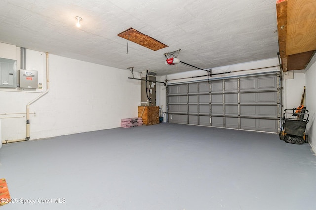 garage featuring a garage door opener and electric panel