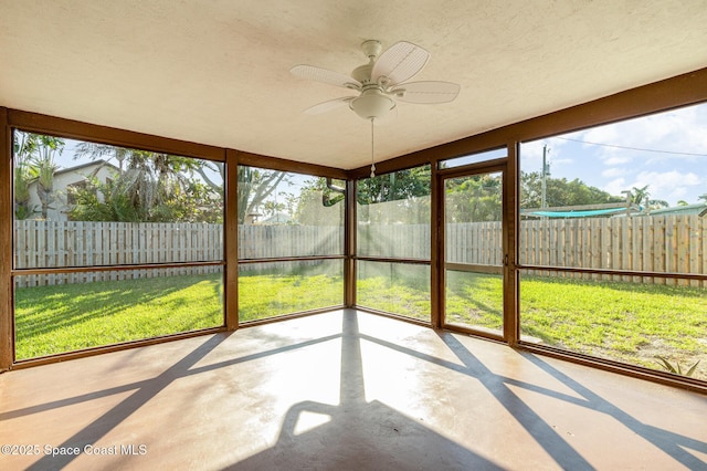 unfurnished sunroom featuring ceiling fan