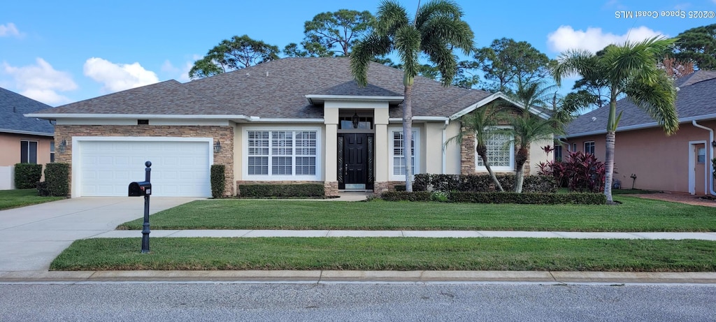 view of front of home with a garage and a front yard