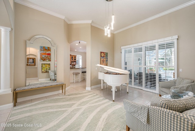 interior space with an inviting chandelier, ornamental molding, decorative columns, and light tile patterned flooring