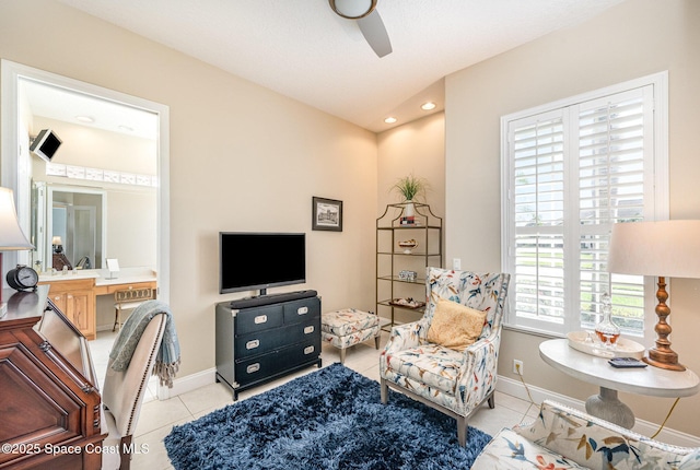 interior space with light tile patterned floors and ceiling fan