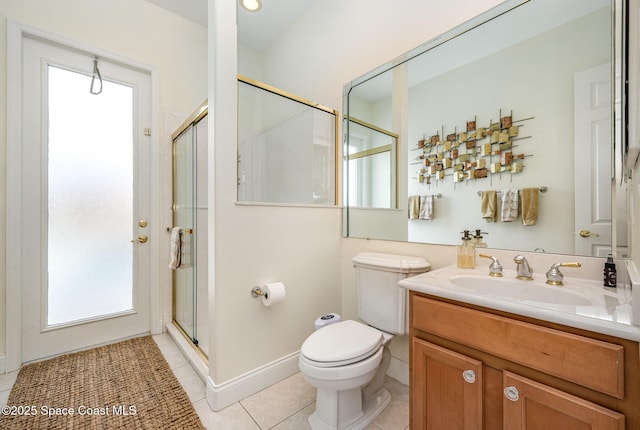 bathroom with vanity, toilet, a shower with shower door, and tile patterned flooring