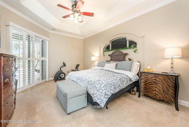 bedroom with a raised ceiling, ornamental molding, light carpet, and ceiling fan