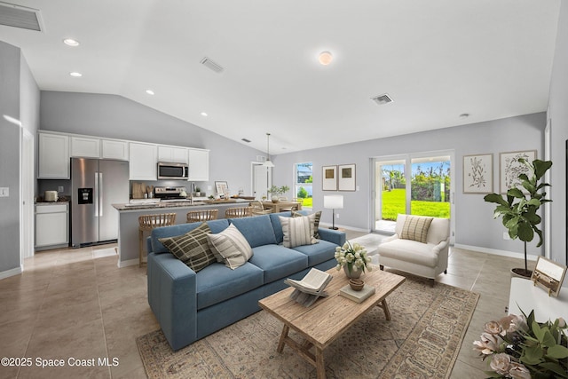 tiled living room featuring high vaulted ceiling