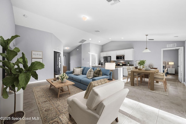 tiled living room featuring vaulted ceiling