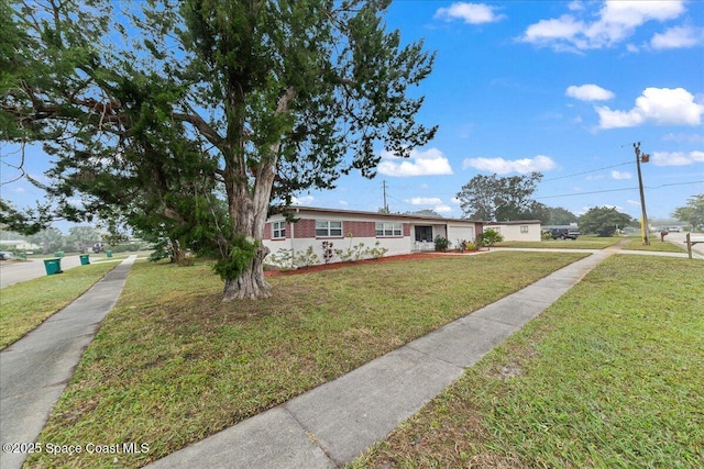 ranch-style home featuring a front yard