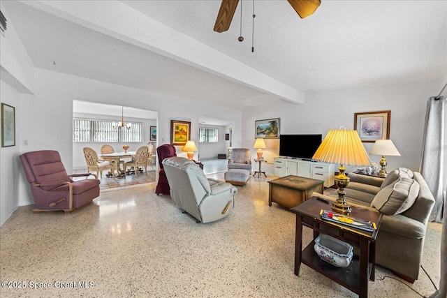 living room featuring beamed ceiling, ceiling fan with notable chandelier, and a wealth of natural light