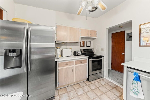 kitchen featuring ceiling fan, stainless steel appliances, and light brown cabinets