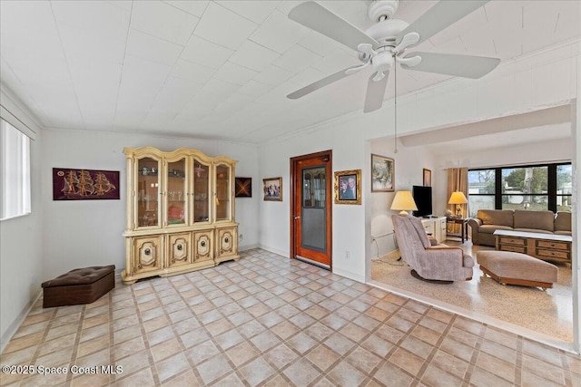 living area with ceiling fan