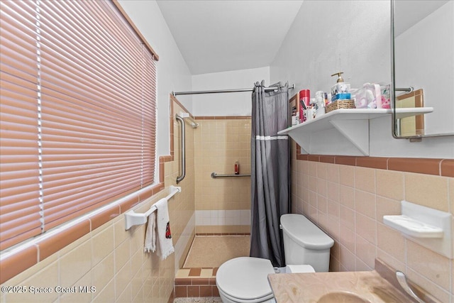 bathroom with vanity, tile walls, curtained shower, and toilet