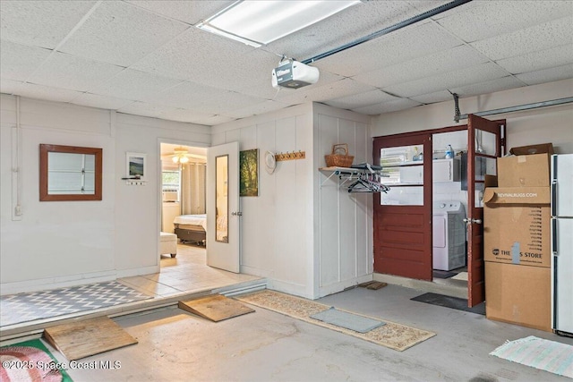 interior space with white refrigerator, a paneled ceiling, and washer / clothes dryer