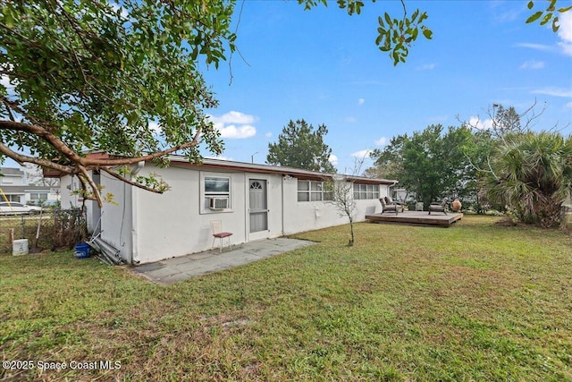 back of house with a wooden deck and a yard