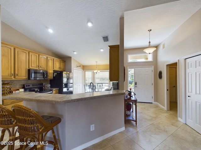 kitchen featuring pendant lighting, a kitchen bar, black refrigerator with ice dispenser, stainless steel range with electric cooktop, and kitchen peninsula