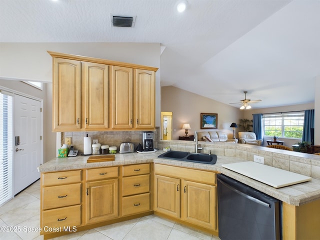 kitchen with lofted ceiling, sink, stainless steel dishwasher, and kitchen peninsula