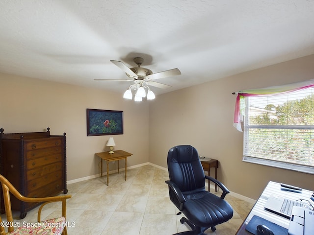 home office featuring light tile patterned floors and ceiling fan