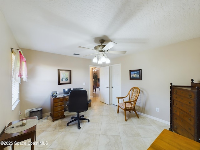 office space with ceiling fan, a textured ceiling, and light tile patterned floors