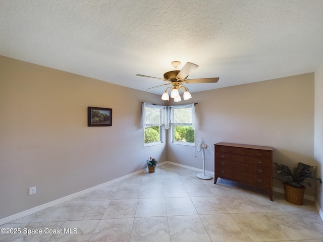 unfurnished room featuring light tile patterned floors, a textured ceiling, and ceiling fan