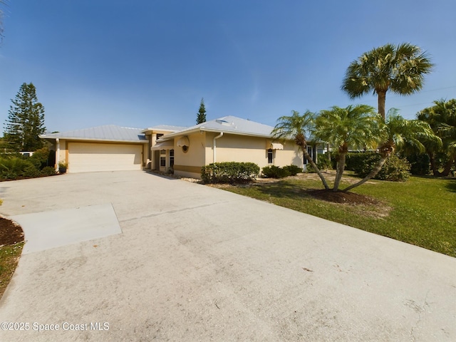 ranch-style home featuring a garage and a front lawn