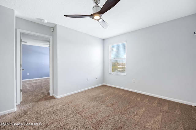 carpeted empty room featuring a textured ceiling and ceiling fan