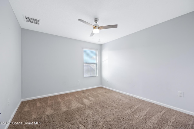 carpeted spare room featuring ceiling fan