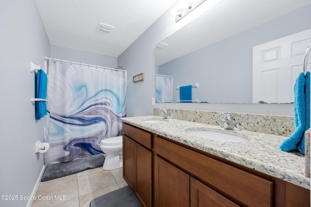 bathroom with vanity, tile patterned floors, and toilet