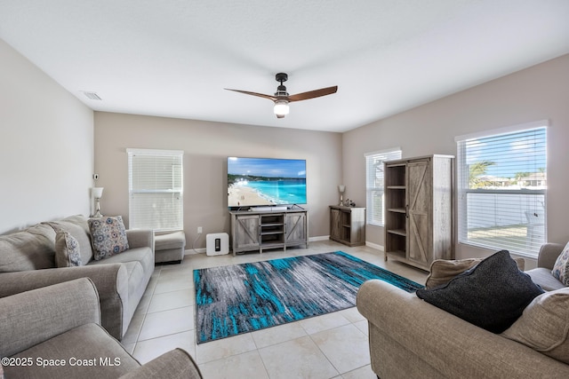 tiled living room with ceiling fan