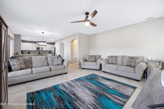 living room with light tile patterned floors and ceiling fan