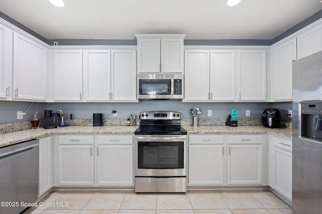 kitchen with white cabinets and appliances with stainless steel finishes