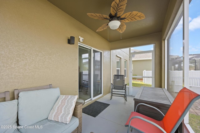 sunroom / solarium featuring ceiling fan