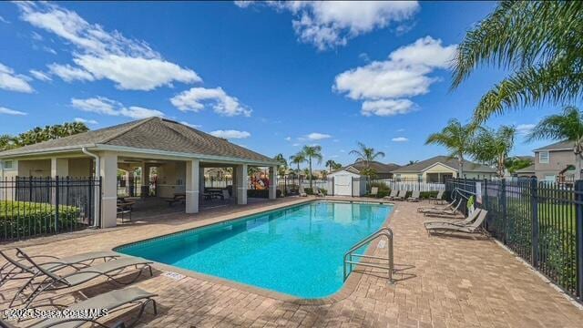 view of pool with an outbuilding and a patio area