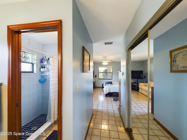 hallway featuring light tile patterned flooring