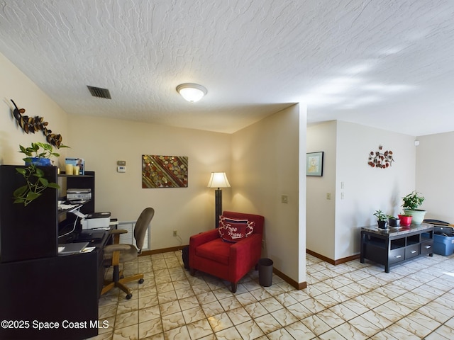 office space with a textured ceiling