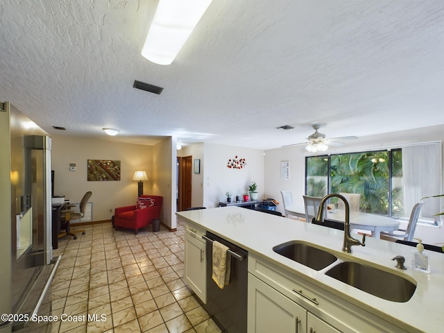 kitchen featuring black dishwasher, sink, ceiling fan, high end fridge, and a textured ceiling